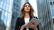 © KKC Studio - Confident Businesswoman with Tablet in Urban Setting