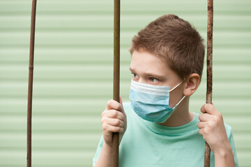 look of the boy with a medical mask holding the lattice