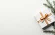 © chali - A minimalist, white background with some Christmas decorations and gift boxes with golden ribbons, top view, flat lay