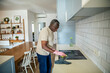 © Geber86 - Senior man cleaning kitchen countertop at home