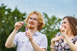 © Voyagerix - Couple blowing soap bubbles, having fun