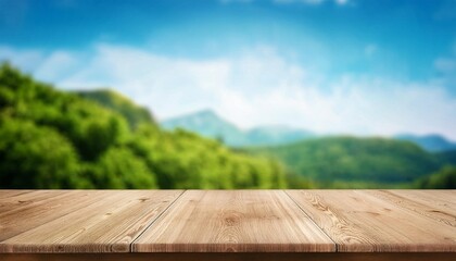 empty wooden table top in front of green mountain and blue sky at summer blurred background