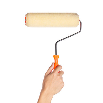 Hand holding paint roller on white background
