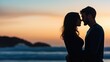 © Nitchalee N. - A romantic silhouette of a couple embracing on the beach at sunset, capturing love and intimacy against a beautiful sky.