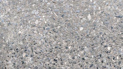 a close-up of a rough, textured concrete surface with visible small stones. perfect for industrial, 