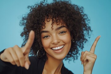 Poster - A woman with curly hair is pointing at the camera, making eye contact