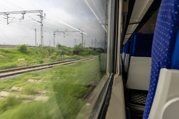 High Speed Passenger Train Window View in Motion During Daytime with motion blur