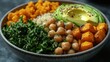 © The prominence - A vibrant Buddha bowl filled with quinoa, roasted sweet potatoes, avocado slices, chickpeas, and leafy greens, drizzled with tahini sauce, arranged neatly in a bowl