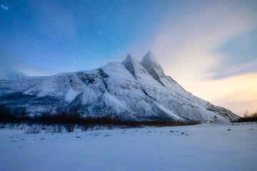 Wall Mural - Otertind mountain, Lyngen Alps, Norway. Natural andscape. Starry sky and moon light. Long exposure photography in the mountain region. Winter night landscape with starry sky.