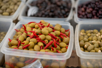 Olives displayed on a farmer's market counter