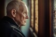© Fotograf - A elderly gentleman gazing out the window, possibly lost in thought