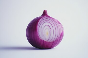 Wall Mural - Fresh red onion cut in half on a white surface, perfect for cooking or photography