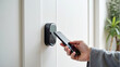 © Mobasser - Hand using smartphone for close digital door lock at home or apartment. keycard, PIN number, smartphone, electrical and contactless lifestyle