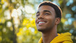 © Victor - Young Man with a Relaxed Smile in the Park, Enjoying Fresh Air and Nature