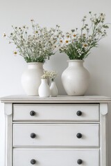 Aufkleber - Decorative vases with fresh flowers on a dresser, perfect for home decor or interior design projects