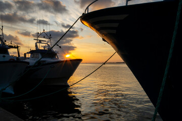 Sunset between two fishing boats