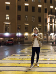 Lifestyle portrait of a teenage boy using a smartphone outdoors