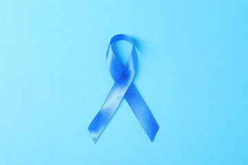 Sticker - Blue ribbon on color background, top view. Prostate cancer awareness