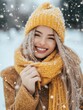 © Sansern - Smiling woman in yellow knit hat and scarf in snow.