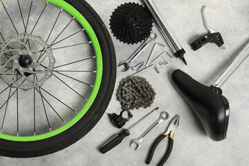 Poster - Parts of bicycle and tools on grey background, flat lay