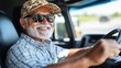 © Anna - An elderly man with a cheerful smile drives a truck while wearing sunglasses and a patterned cap. The bright day and open road set a carefree and relaxed mood