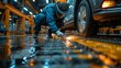© liliyabatyrova - A man in a blue jumpsuit is working on a car
