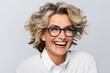 © Igor - Portrait of a happy mature woman in eyeglasses over grey background