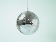 © Kittipong - Sparkling Disco Ball Closeup On Light Blue Background - Festive Party Celebration Concept