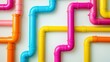 © Sergey - colorful plastic plumbing pipes intersecting in a geometric pattern, set against a bright white wall