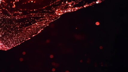Poster - Dynamic drops of red glitter in black oil or ink diffusing through liquid, creating an abstract aquatic swirls