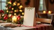 © Indi - festive holiday decorated table setting with focus on empty white menu card standing upright on table, warmly lit restaurant with Christmas tree in background.restaurant promotions or menus concept.