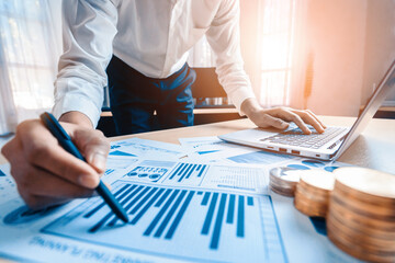 Wall Mural - Businessman accountant or financial expert analyze business report graph and finance chart at corporate office. Concept of finance economy, banking business and stock market research. uds