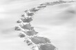 © Konstiantyn Zapylaie - Curved footprints in fresh snow on a winter day