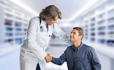 Canvas Print - Young smart doctor with patient consulting in hospital.