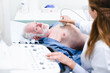 © InsideCreativeHouse - Close up photo of mature male patient undergoing ultrasound examination with female doctor in the foreground