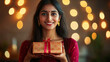 © Creative Valley - Diwali Festival at Home, Woman Holding Beautiful Gift Box, Warm Indoor Setting