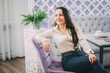 © komokvm - Smiling Woman Relaxing in Cozy Cafe Environment