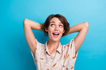 Wall Mural - Photo of creative gorgeous person hands behind head look interested empty space isolated on blue color background