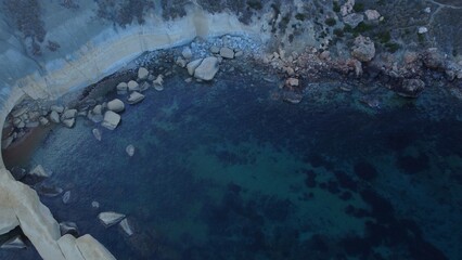 Rocky beach and sapphire sea water on the Maltese island, mediterranean sea, Ghajn Tuffieha bay , Malta. High quality photo