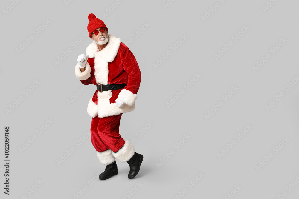 Cool Santa Claus in sunglasses on grey background