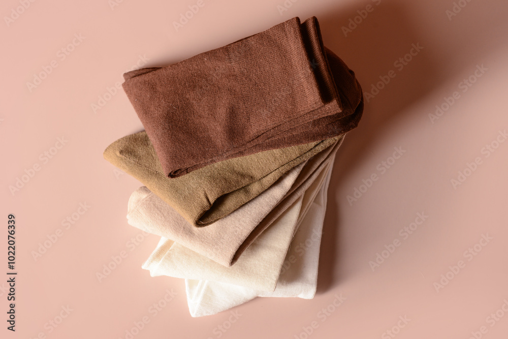 Stack of basic color socks on beige background