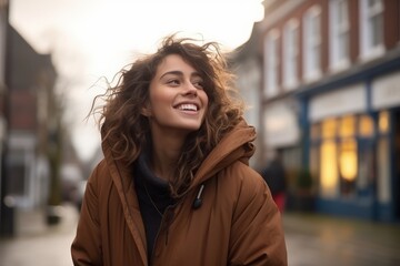 Portrait of a beautiful young woman in a coat smiling at the camera