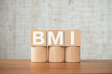 Poster - There is wood cube with the word BMI. It is an abbreviation for Brain Machine Interface as eye-catching image.