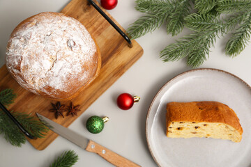 Poster - Tasty Panettone with knife and Christmas decor on grey background