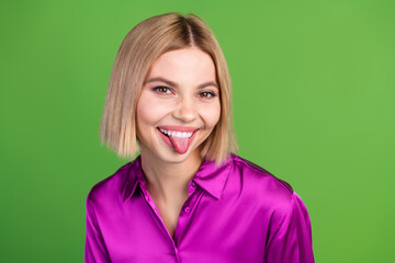 Canvas Print - Photo of pretty young woman show tongue wear purple shirt isolated on green color background