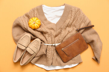 Canvas Print - Stylish female bag with knitted sweater, shoes and autumn decor on beige background