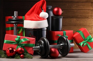 Wall Mural - Dumbbells, containers with supplement and Christmas decor on wooden table