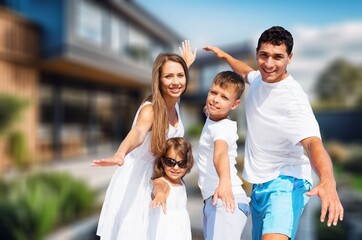 Portrait of happy young family with kid at new house