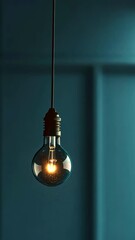 Poster - Illuminated light bulb hanging against dark background, modern design concept