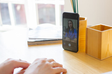 Woman recording video on her smartphone. Female blogger making content for social media. Facetime call. Girl calling to friend. Online conference and meeting